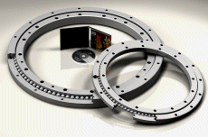 The large axial loadings are accomodated by large diameter four point contact bearings.  The main bearing is approximatly 80% of the faceplate size and therefore can adapt for large moment loads caused by offset loadings.
